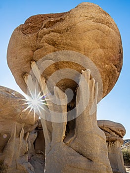 Uniquely Eroded Geologic Sandstone Formation With Sunburst photo