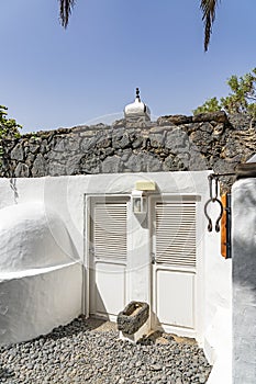 Details of a white house with walls made of black lava stone on the island of Lanzarote, Spain