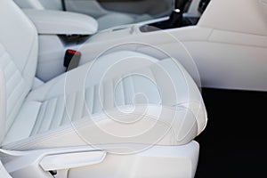 Details of white leather seat in a luxury car.