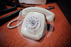 Details with a white old fashioned dial rotary phone from the communist Romania era