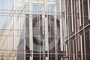 Details with the windows and glass walls and reflections in them of an office/business modern building