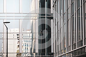 Details with the windows and glass walls and reflections in them of an office/business modern building