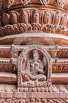 Detail of wood carving of deity on Hindu temple in Kathmandu, Nepal