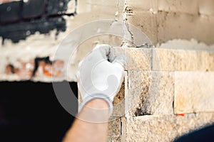 details of worker hands using cement and stone. Construction mason worker at work