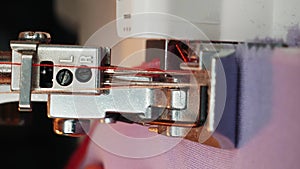 Details of working sewing machine. Sewing needle with thread. Vertical video