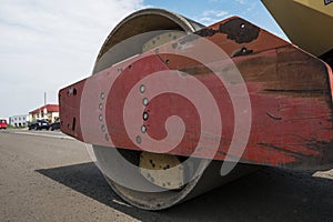 Details of yellow red Heavy Vibration roller compactor at asphalt pavement works for road repairing. Working on the new