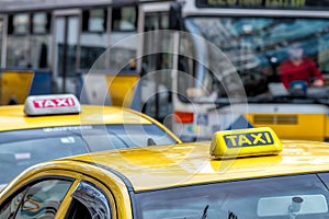 Details of yellow taxi cars on the street.
