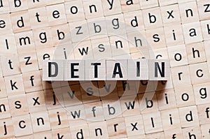 Detain word concept on cubes photo