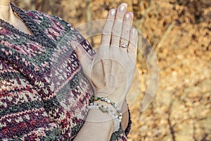 Detal of woman doing namaste hand mudra pose photo