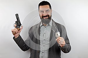 Detective with beard smiling showing police badge holds the gun with his arm up.