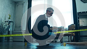 Detective Collecting Evidence in a Crime Scene. Forensic Specialists Making Expertise at Home of a Dead Person. Homicide