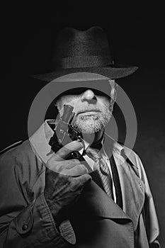 Detective holding a gun in the dark
