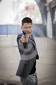 Detective or mobster or policeman aiming a firearm