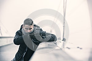 Detective or mobster or policeman aiming a firearm photo