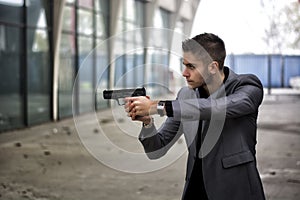Detective or mobster or policeman aiming a firearm