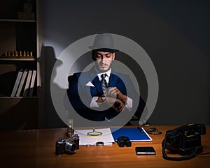 Detective sitting in dark room in vintage concept