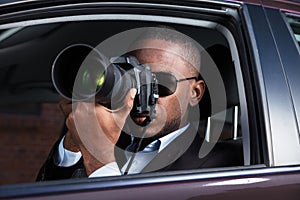 Detective Sitting Inside Car Photographing