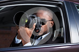 Detective Sitting Inside Car Photographing photo