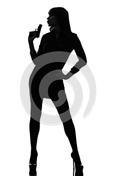 detective woman holding aiming gun silhouette