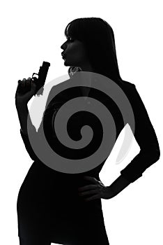 detective woman holding aiming gun silhouette