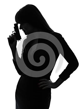 detective woman holding aiming gun silhouette