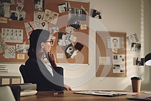 Detective working at desk in her office