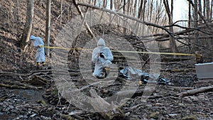 Detectives are collecting evidence in a crime scene. Forensic specialists are making expertise. Police investigation in