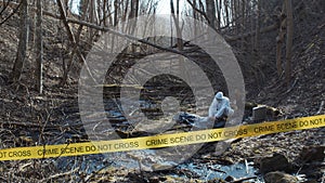 Detectives are collecting evidence in a crime scene. Forensic specialists are making expertise. Police investigation in