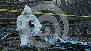 Detectives are collecting evidence in a crime scene. Forensic specialists are making expertise. Police investigation in