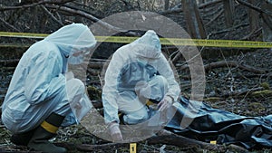 Detectives collecting evidence in a crime scene. Forensic specialists making expertise. Police officers and