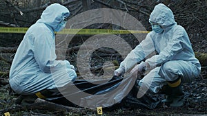 Detectives collecting evidence in a crime scene. Forensic specialists making expertise. Police officers and