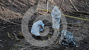 Detectives collecting evidence in a crime scene. Forensic specialists making expertise. Police officers and