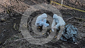 Detectives collecting evidence in a crime scene. Forensic specialists making expertise. Police officers and