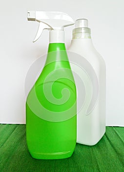 Detergent bottle and towels on white background