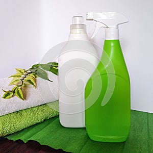 Detergent bottle and towels on white background