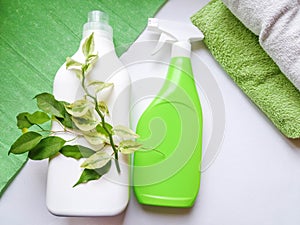 Detergent bottle and towels on white background