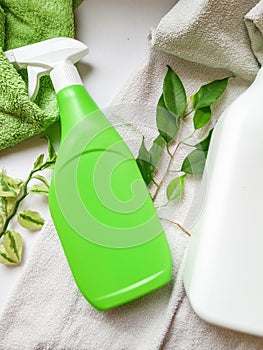 Detergent bottle and towels on white background