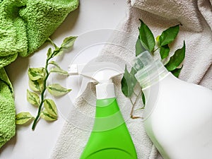 Detergent bottle and towels on white background