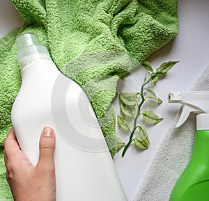 Detergent bottle and towels on white background