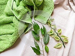 Detergent bottle and towels on white background