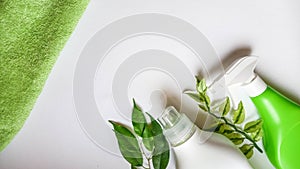 Detergent bottle and towels on white background