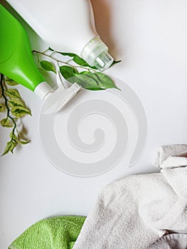 Detergent bottle and towels on white background