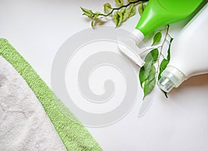 Detergent bottle and towels on white background