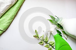 Detergent bottle and towels on white background.