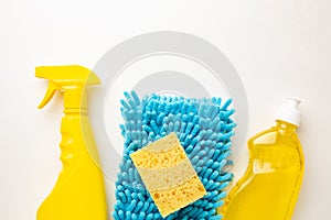 Detergent bottles and blue sponges isolated on white background