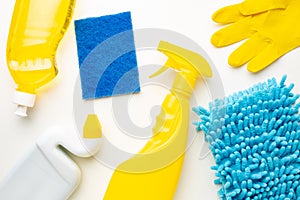 Detergent bottles and blue sponges isolated on white background