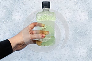 Detergent bottles float in the foam. The concept of the dangers of household chemicals. Laureate of sodium, parabens, sulfates and