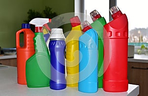 Detergent bottles at kitchen in home. Detergents and laundry concept. Household chemicals for cleaning. Concentrated additive.