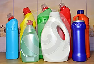 Detergent bottles at kitchen in home. Detergents and laundry concept. Household chemicals for cleaning. Concentrated additive.