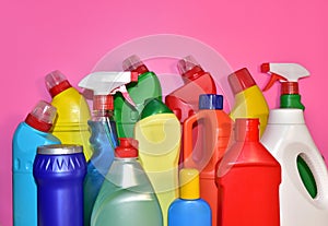 Detergent bottles on pink background. Detergents and laundry concept. Household chemicals for cleaning. Chemical liquid for